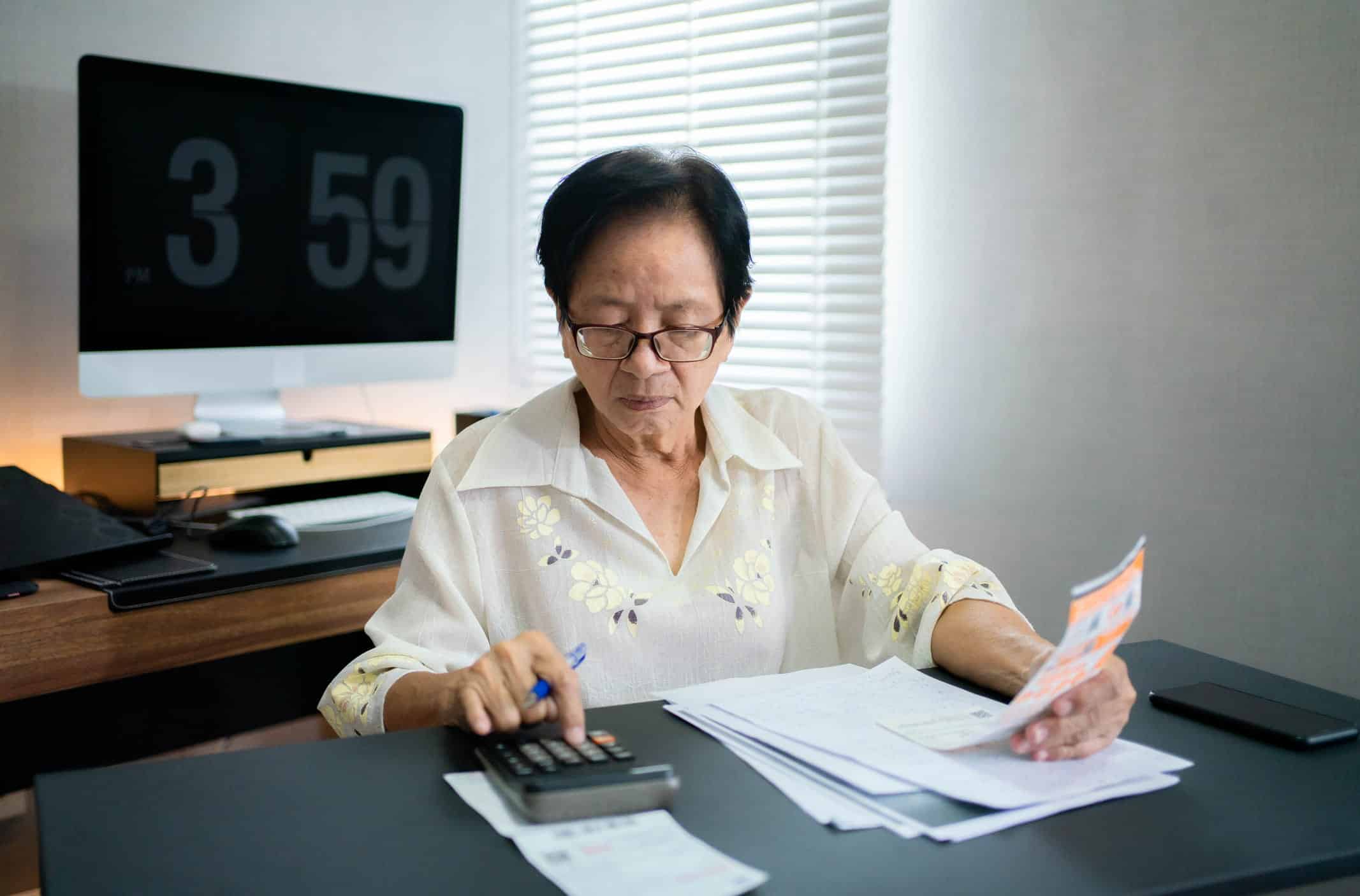 elderly woman calculating expenses and filing for bankruptcy