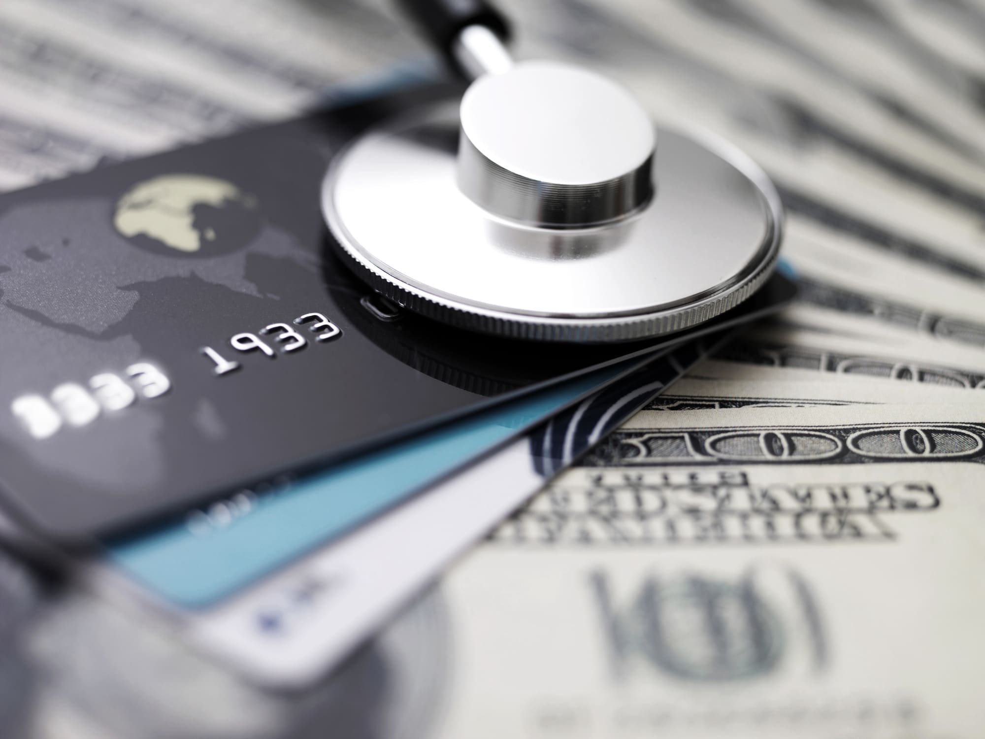 medical device on top of credit cards and USD cash